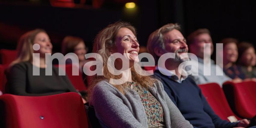 Crowded Movie Theater with People Seated Facing a Blank Screen in a Modern, Comfortable Setting with Blue and Orange Lighting
