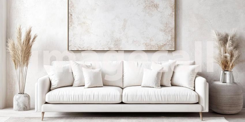 A luxurious living room, bathed in soft light, exudes an aura of tranquility with its elegant white furnishings, ornate details, and a captivating artwork that adds a touch of ethereal beauty