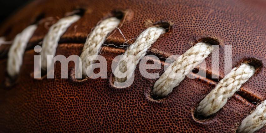 A Touch of History: A Close-Up of a Well-Worn Leather Football, Its Stitching and Grain Telling Stories of Past Games and Gritty Glory