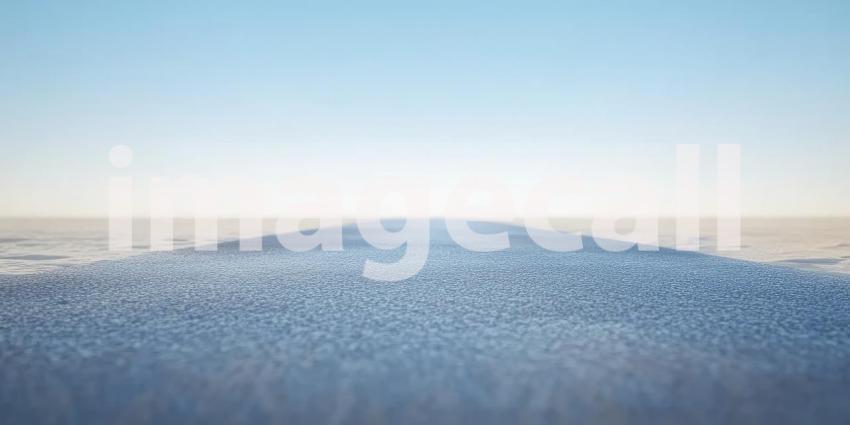 A solitary road stretches towards the horizon, vanishing into the vast expanse of the desert under a clear blue sky