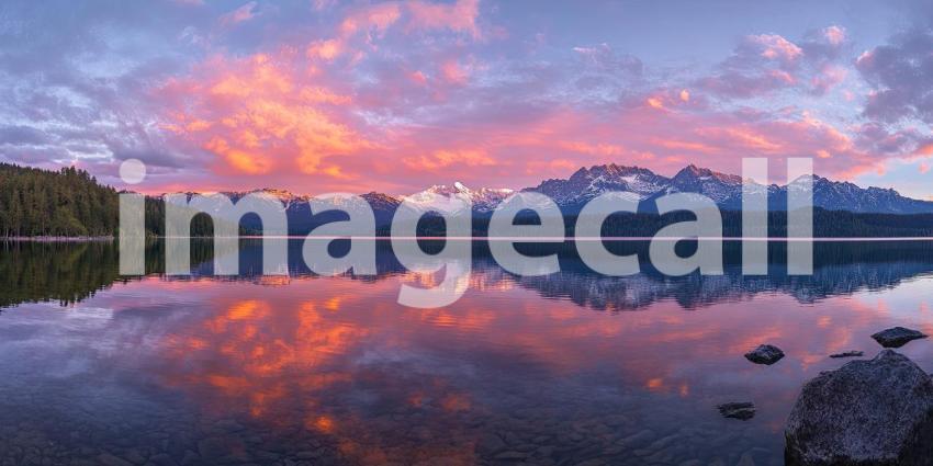 A Fiery Reflection: A dramatic sunset paints the sky with vibrant hues, mirroring the spectacle on the tranquil surface of a mountain lake
