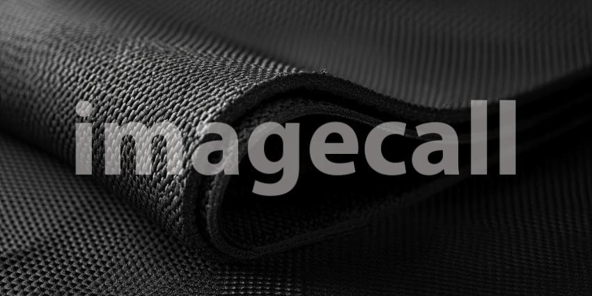 A Tapestry of Texture: A close-up of a dark, textured fabric, with intricate patterns and subtle shadows, evokes a sense of depth and sophistication